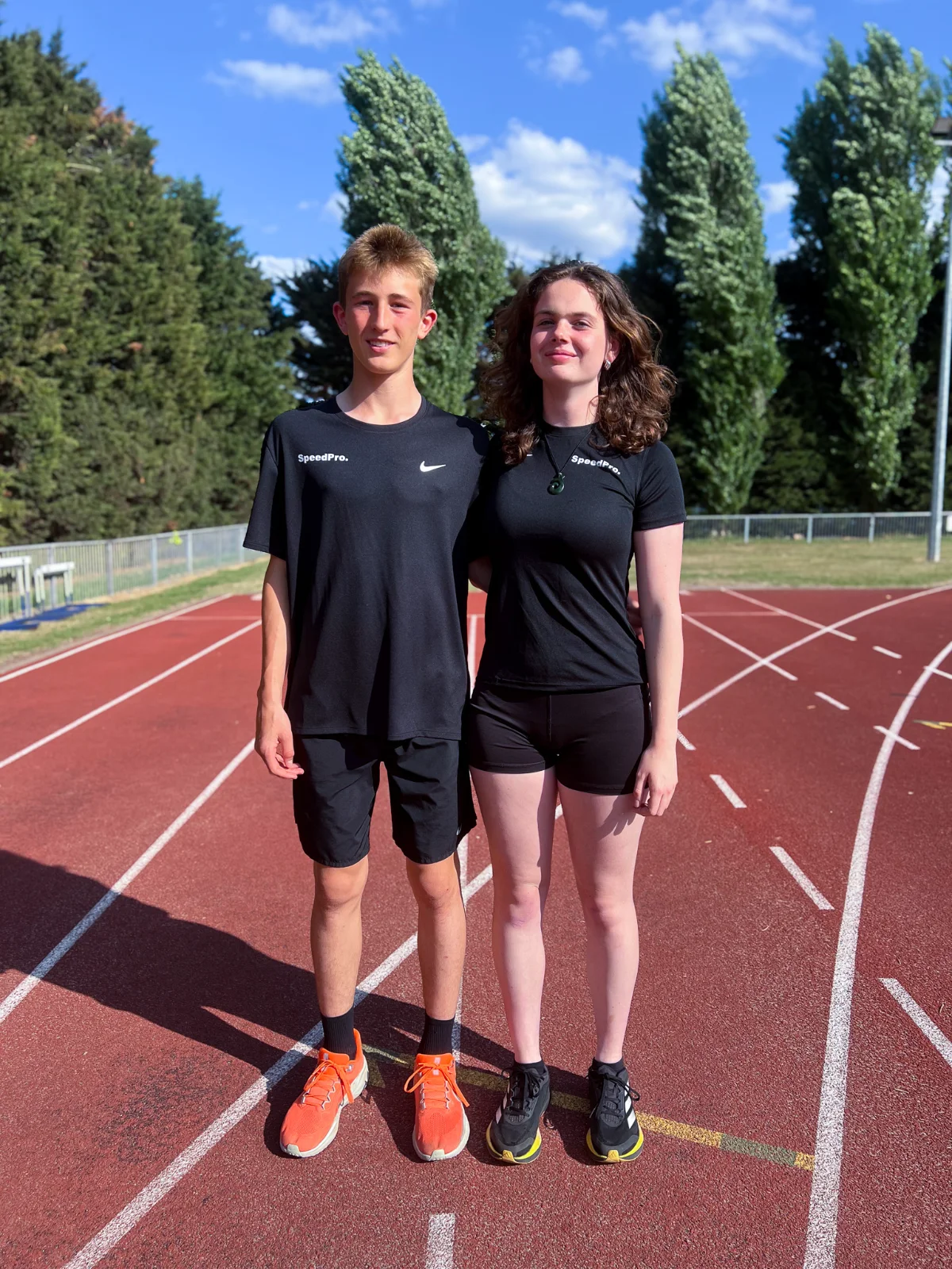 SpeedPro athletes Thomas Whorton and Neva Jansen in black SpeedPro Nike training T-shirts on the track
