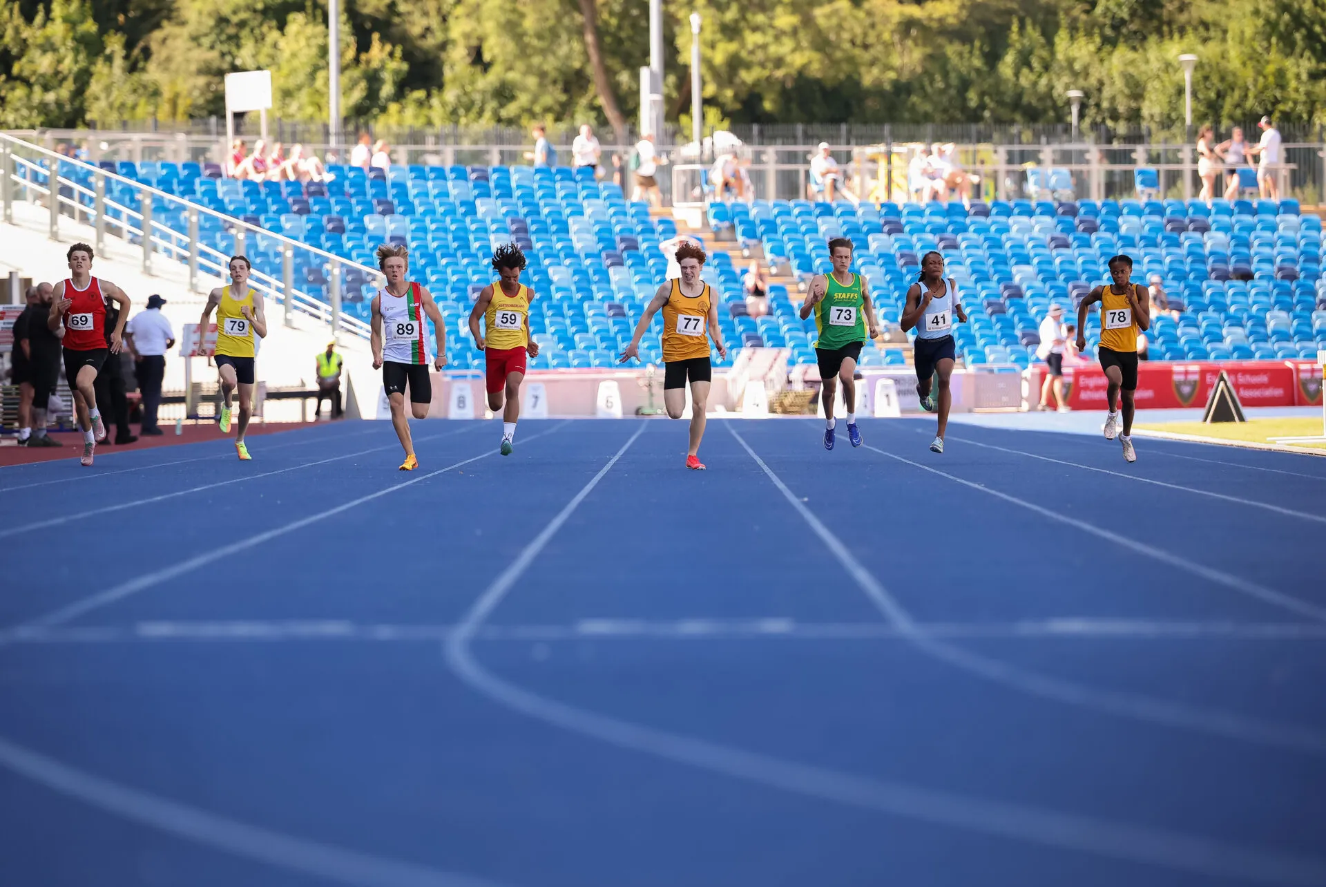 SpeedPro athlete Tommy Crosara (77) approaching the finish line to win the 2025 English Schools 300m title
