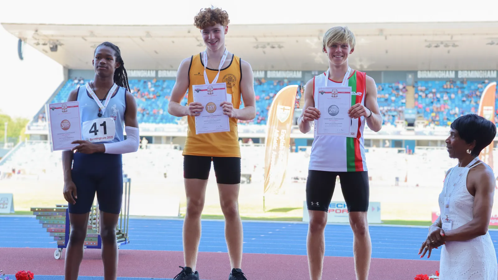 Tommaso Crosara on top of the podium with his first place certificate after winning the English Schools Junior Boys 300m in Birmingham