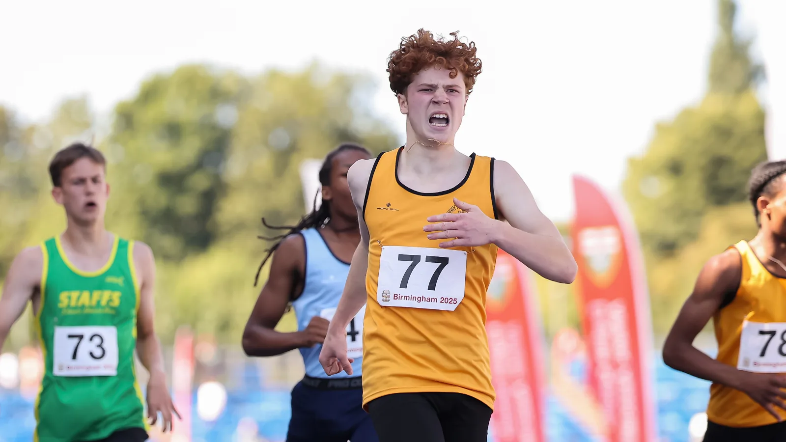 SpeedPro athlete Tommaso Crosara, number 77, driving for the line in the 300m at the English Schools Championships in Birmingham