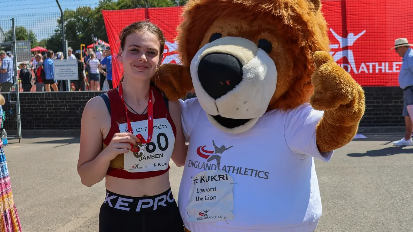 SpeedPro athlete Neva Jansen with her U18 discus bronze medal and the England Athletics mascot at the 2026 National Age Group Championships