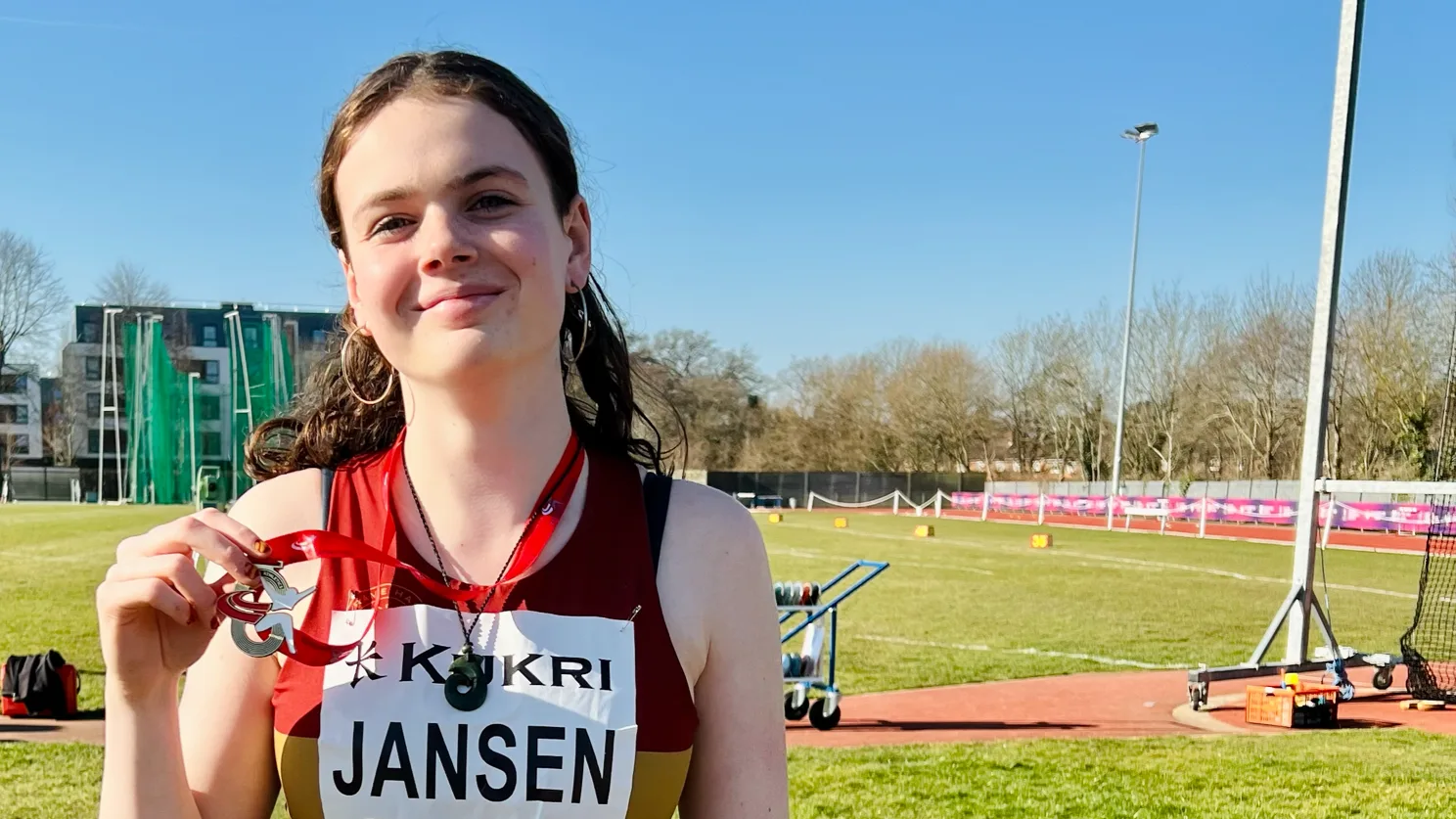 SpeedPro athlete Neva Jansen smiling with her national discus bronze medal
