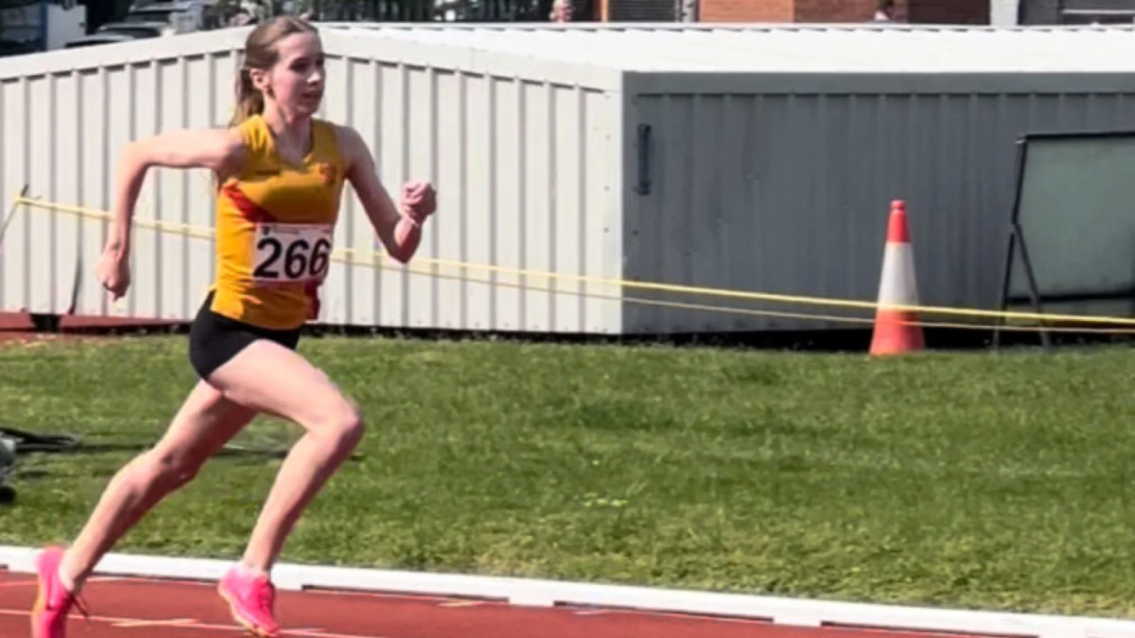 SpeedPro athlete Freya McAndie, number 266, sprinting at the Surrey Championships