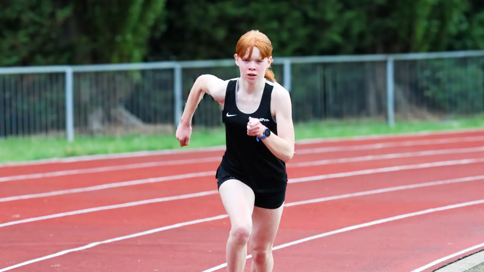 SpeedPro athlete sprinting round the bend at a summer training session
