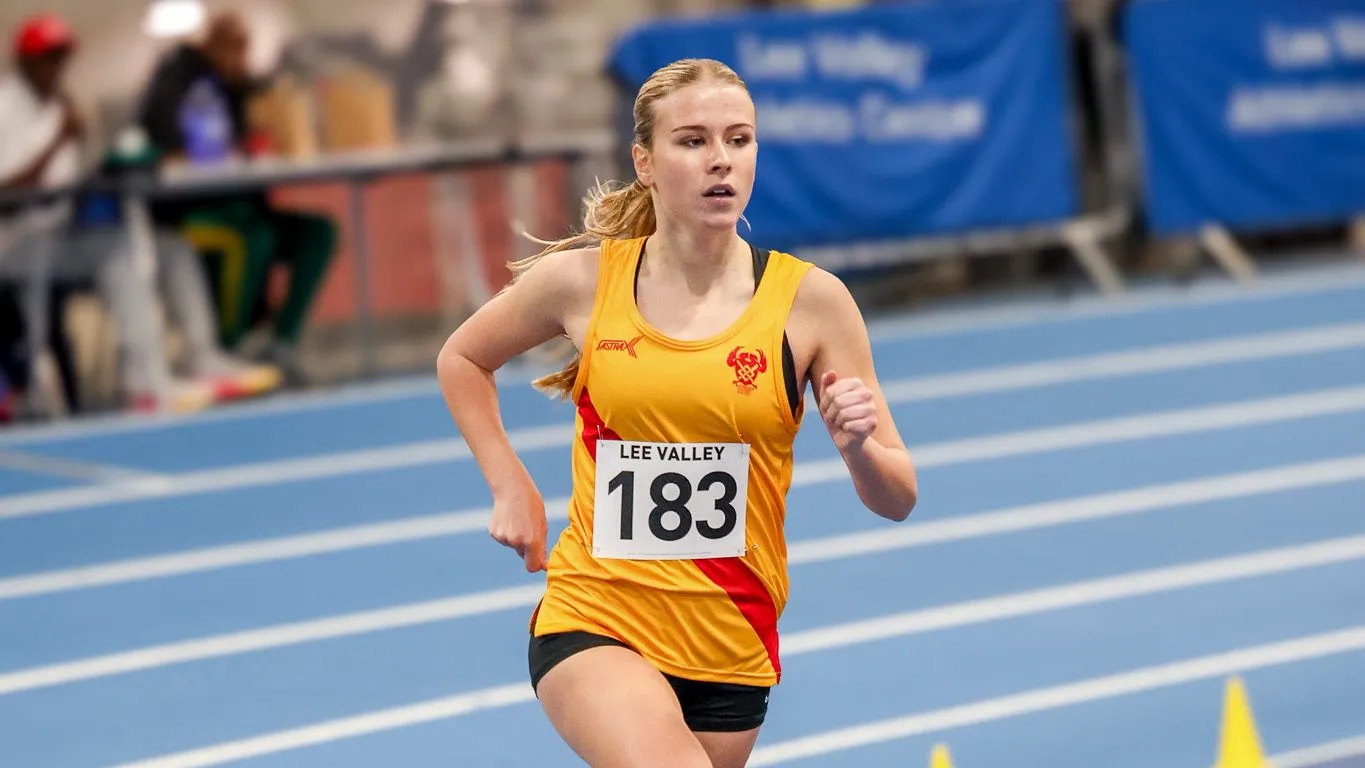 SpeedPro athlete racing on the bend of the indoor track at the Lee Valley December Open