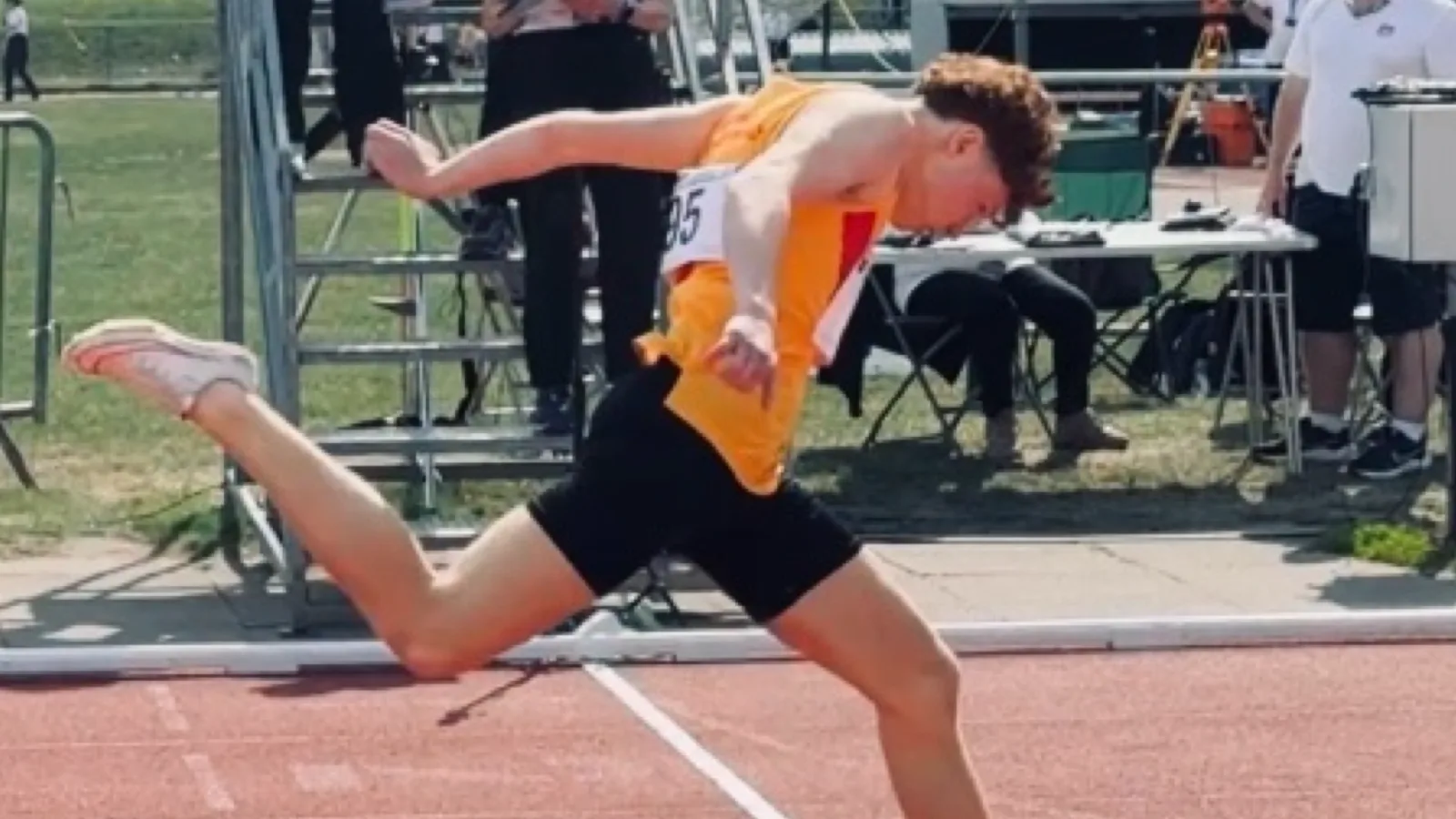 SpeedPro sprinter dipping for the line at the Surrey County Track and Field Championships