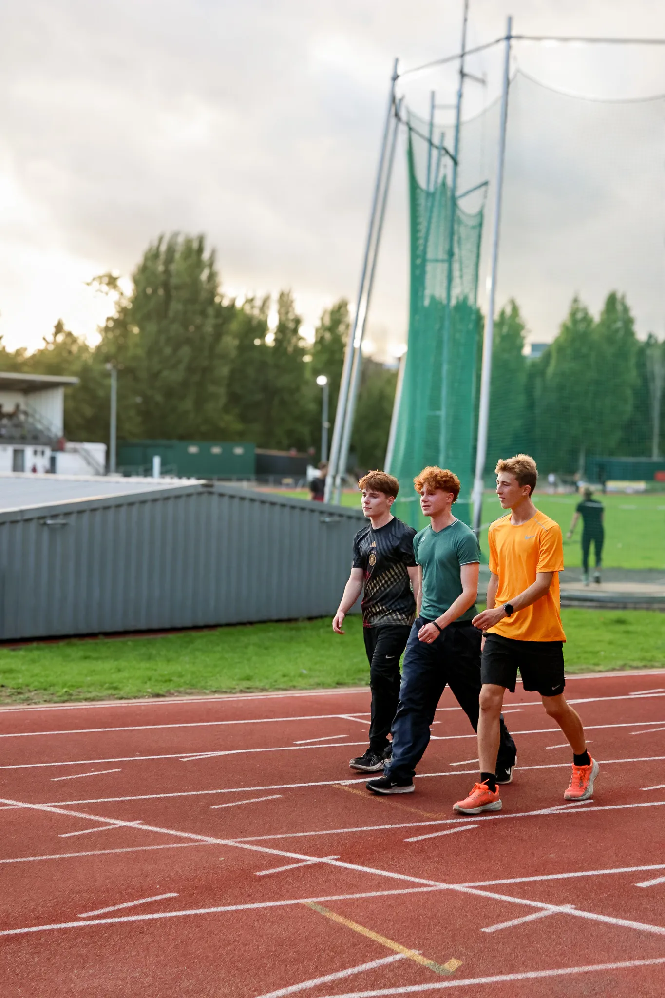 SpeedPro athletes Soren Kerner, Tommy Crosara and Thomas Whorton walking the track together at an evening training session